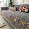 Gray sofa covers decorated with gold and white Christmas patterns, featuring festive accents.