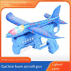 A blue foam aircraft gun with a lighted plate and wings is shown launching a foam plane.