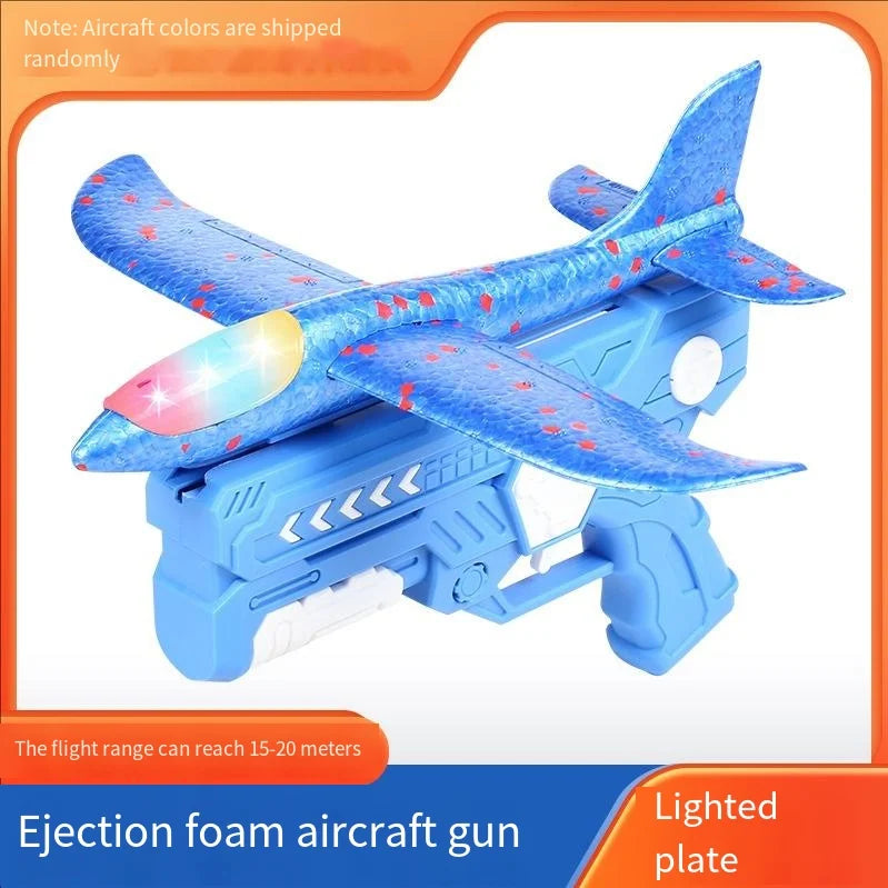 A blue foam aircraft gun with a lighted plate and wings is shown launching a foam plane.
