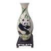 A ceramic vase shaped like a panda, featuring a green leaf pattern and a white background.