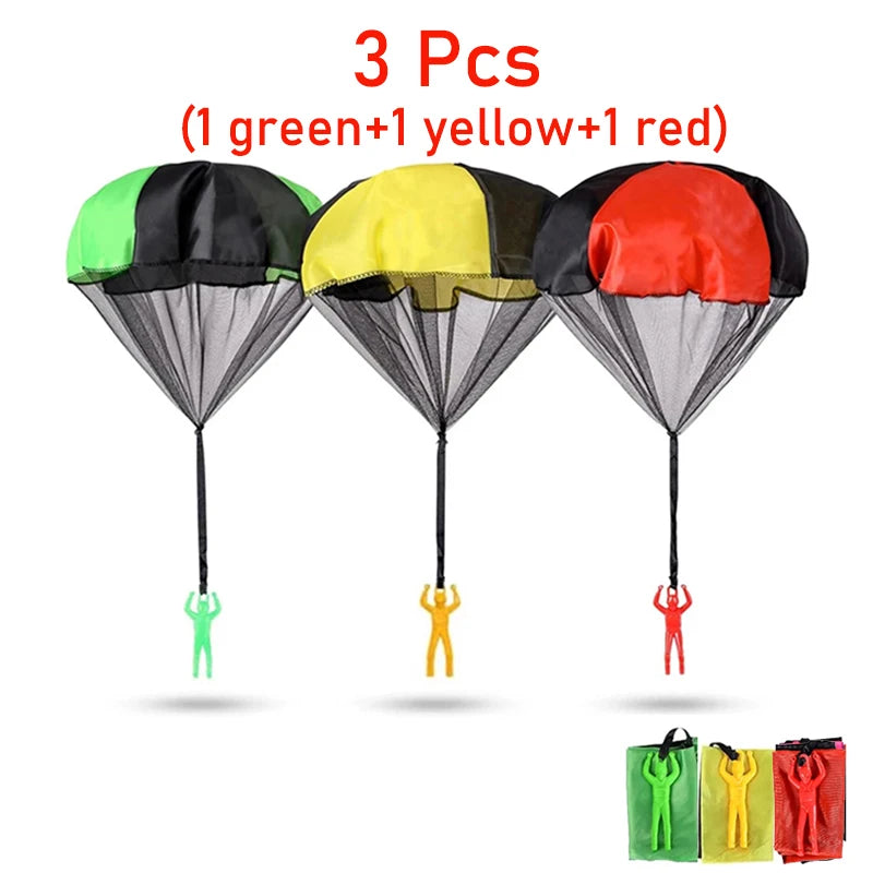Three colorful hand-thrown parachute toys in green, yellow, and red with small figures.