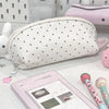 A white polka dot shell-shaped pencil case with a zipper and a pink pencil case are displayed on a white surface.
