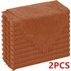 A stack of six rust-colored, raw-edge polyester cloth napkins.