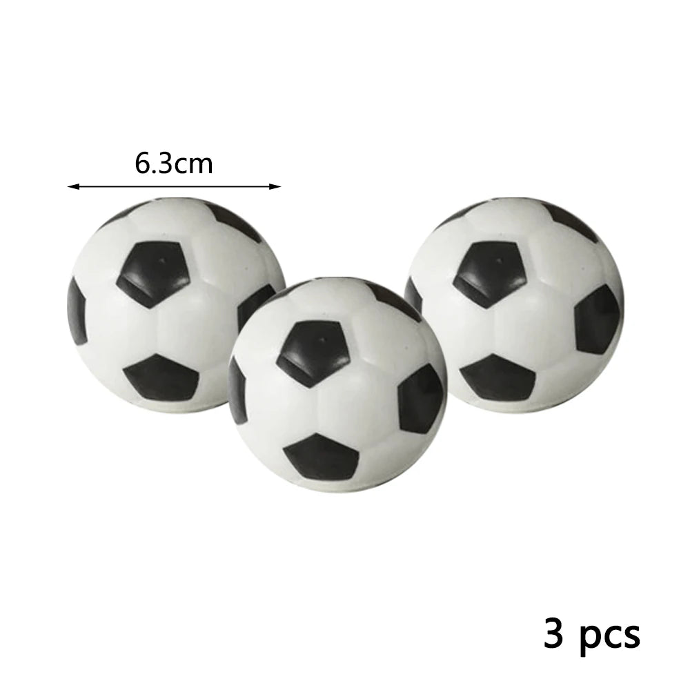 A set of three black and white soft foam sports stress balls, with a dimension marker showing 6.3cm.