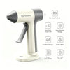 A white cordless glue gun with a gray handle and precision nozzle, shown with features like fast preheat and a stable base.