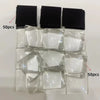 A collection of clear glass cabochons and black magnets for a dome magnet making kit.
