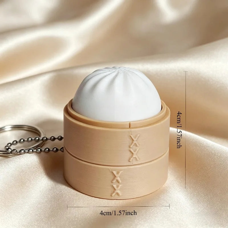 A beige silicone fidget keychain featuring a white, dome-shaped cake design.