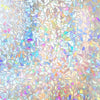 Abstract stained glass pattern featuring iridescent rainbow colors and light reflections.