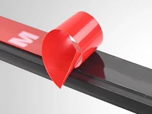 A red light kit component is shown on a black surface, featuring an 'M' logo and a pointed shape.