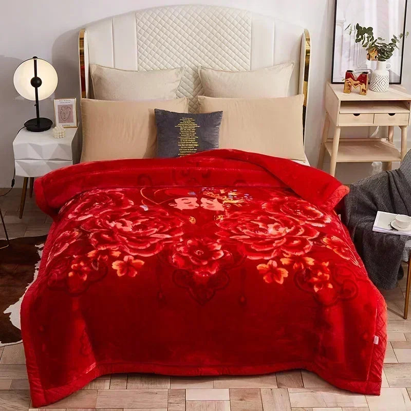 A red weighted plush blanket is displayed on a bed with white and beige pillows.