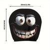 A black cushion cover featuring a cartoon smiley face with wide eyes and a large, toothy grin.