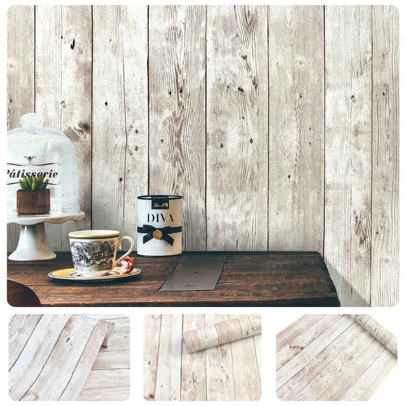 A rustic wooden table with a glass teapot, a tin, and a dark mat set against a light wood plank background.