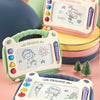 A set of three magnetic drawing boards for kids with erasable pens stacked on a pink surface.