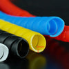 A close-up of various colored cable protector sleeves, including red, blue, yellow, and black, showing an 8mm diameter.