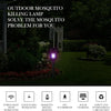 A purple light mosquito killing lamp outdoors in a garden setting.