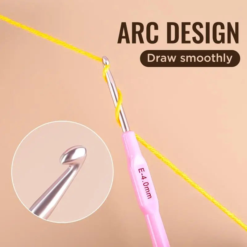 A pink aluminum alloy crochet hook with an ergonomic handle is shown drawing a yellow thread for arc design.