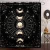 A shower curtain featuring a bold black and white design of celestial bodies, moons, and stars.