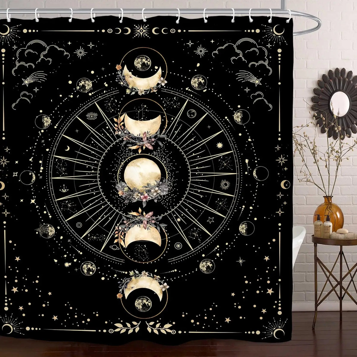 A shower curtain featuring a bold black and white design of celestial bodies, moons, and stars.