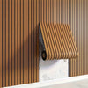 A close-up of wood grain peel-and-stick wall tiles installed vertically on a beige wall.
