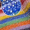 Assortment of faceted crystal glass spacer beads in various colors including blue, green, orange, and purple.