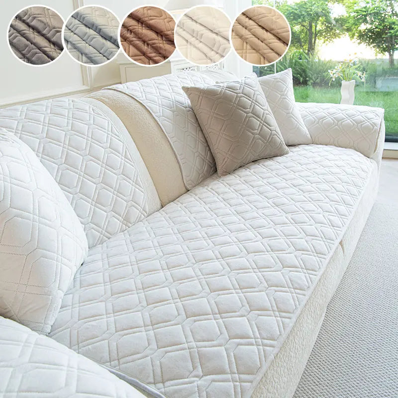 A white quilted anti-slip sofa cover featuring a geometric pattern and beige trim.