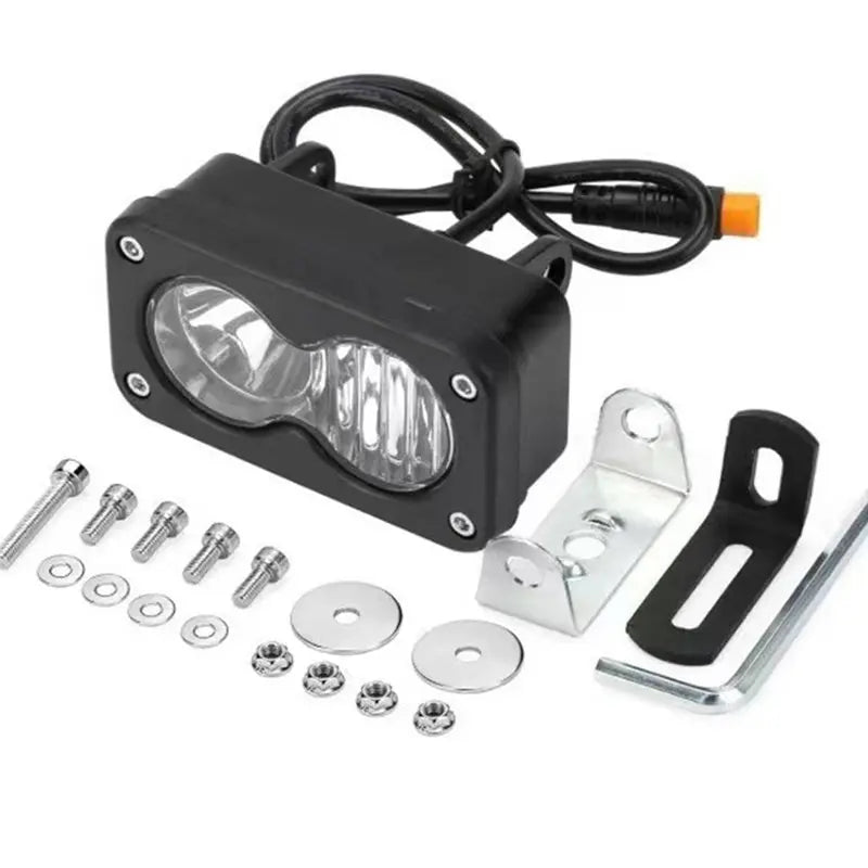 Black high-intensity waterproof LED pod spotlight headlight with wiring and mounting hardware.