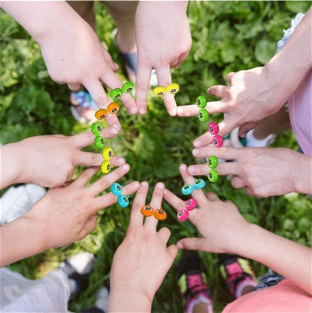 Hands of children forming a circle with colorful eye finger puppet rings for a party favor set