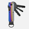 A minimalist aluminum key organizer with a slot for holding keys and a set of metal keys attached.