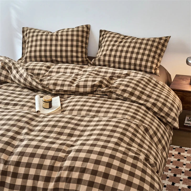 A plaid duvet cover in brown and beige tones with a checkered pattern, featuring decorative pillows.