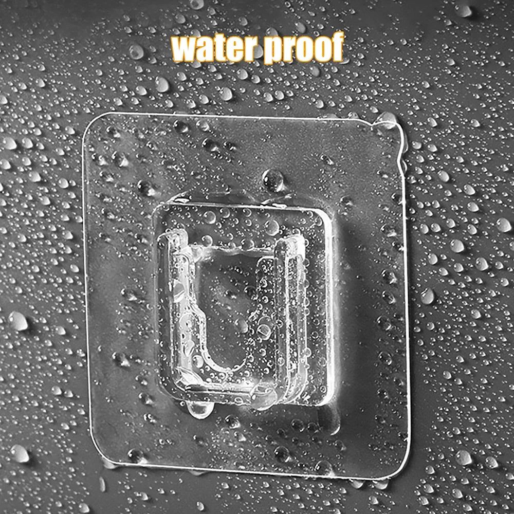 Clear plastic adhesive hooks placed on a water-proof surface covered in water droplets.