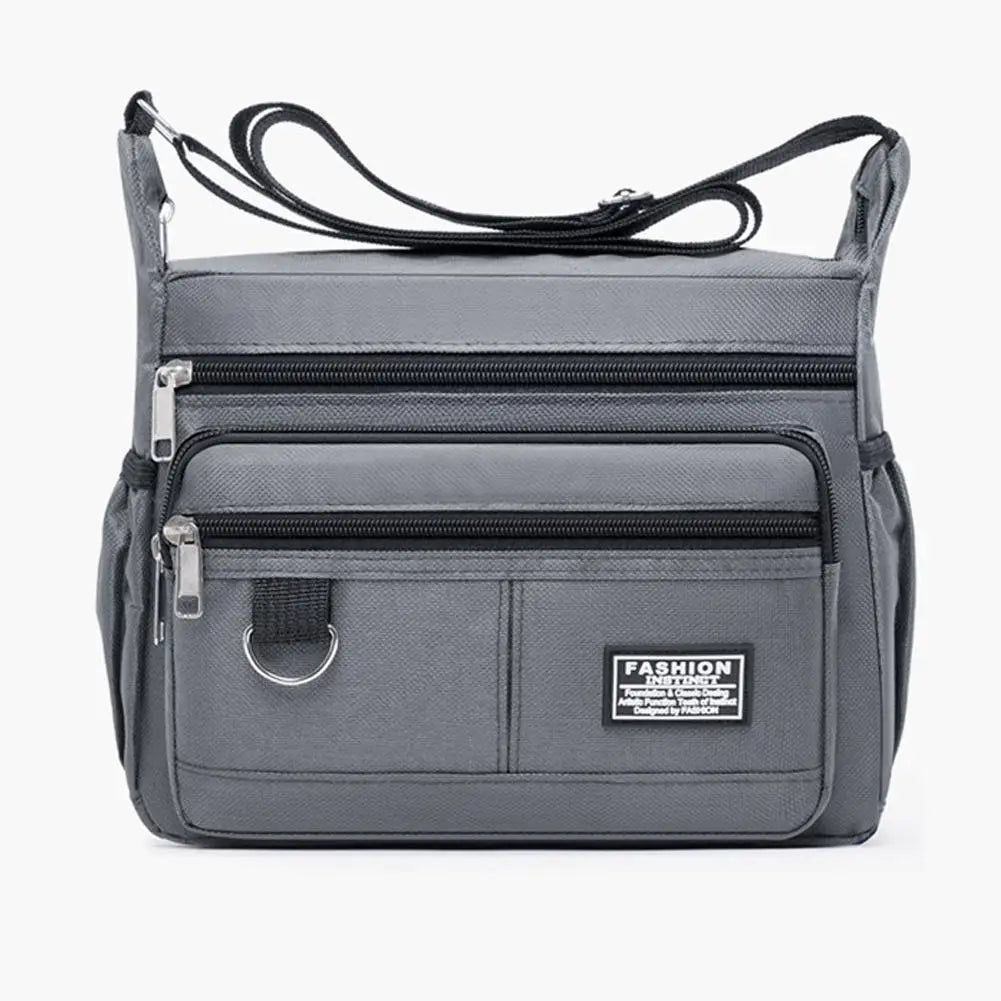 A gray men's waterproof crossbody bag with multiple zippered pockets shown from the front.