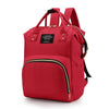 A red insulated canvas mummy diaper bag with a hanging hook and zippered pockets.