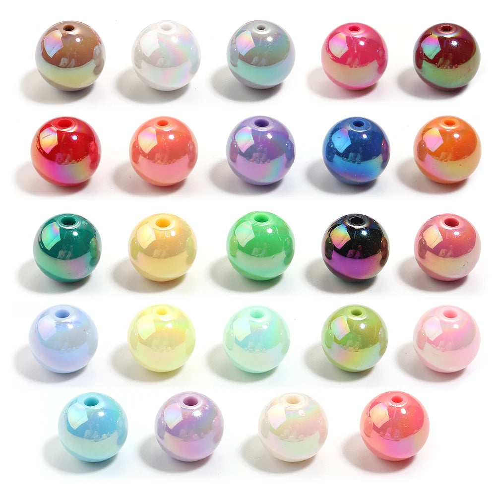 A collection of colorful acrylic round beads in various shades including pink, green, blue, and multicolored patterns.
