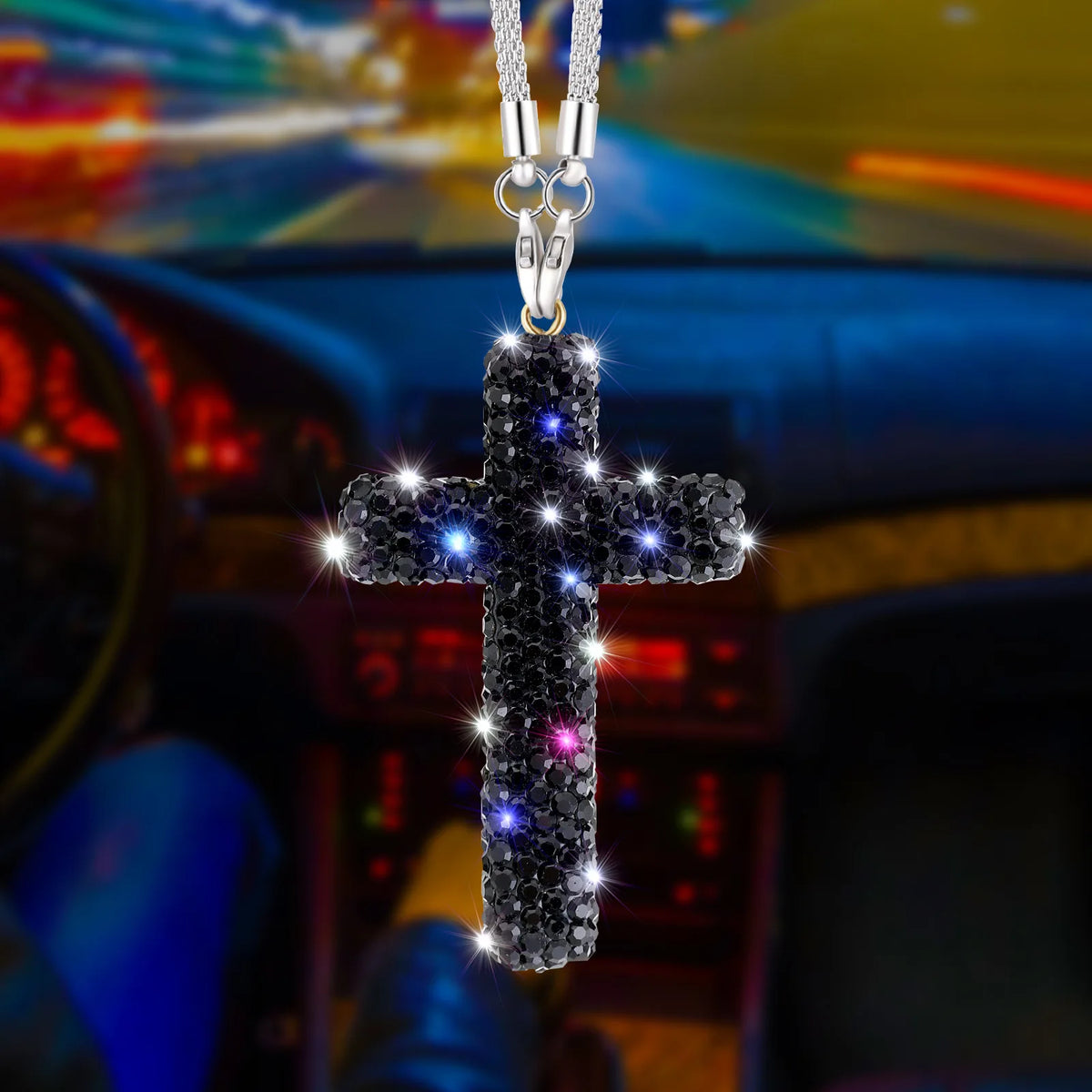 A stainless steel cross pendant adorned with sparkling rhinestones hanging from a chain.