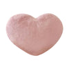 A soft, pink heart-shaped plush throw pillow for cozy decor.