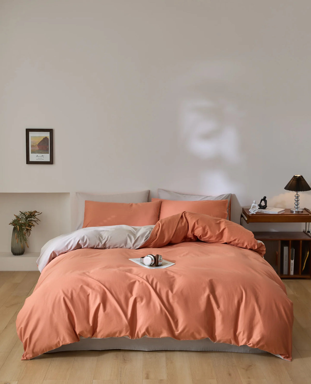 A soft peach quilted duvet cover set displayed on a bed with light wood flooring and a neutral wall.