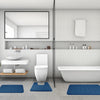 A modern bathroom featuring a white toilet, vanity, and bathtub with blue non-slip bath mats on the floor.