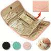 A pink foldable waterproof jewelry roll with compartments for storing and traveling with accessories.