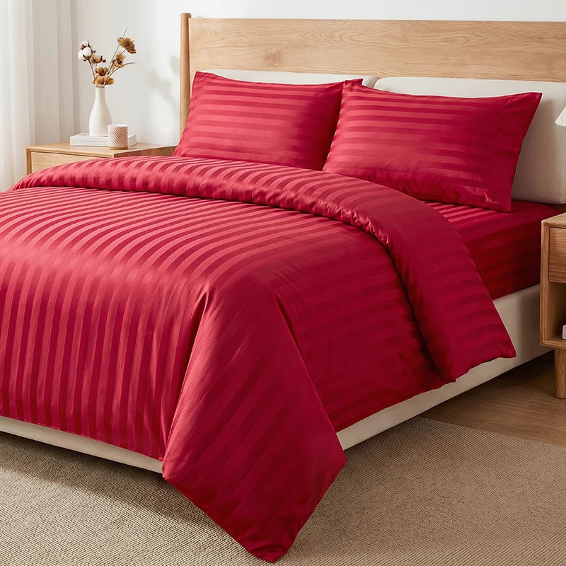 A set of satin striped jacquard duvet covers in deep red with a light wood bed frame and neutral bedding.