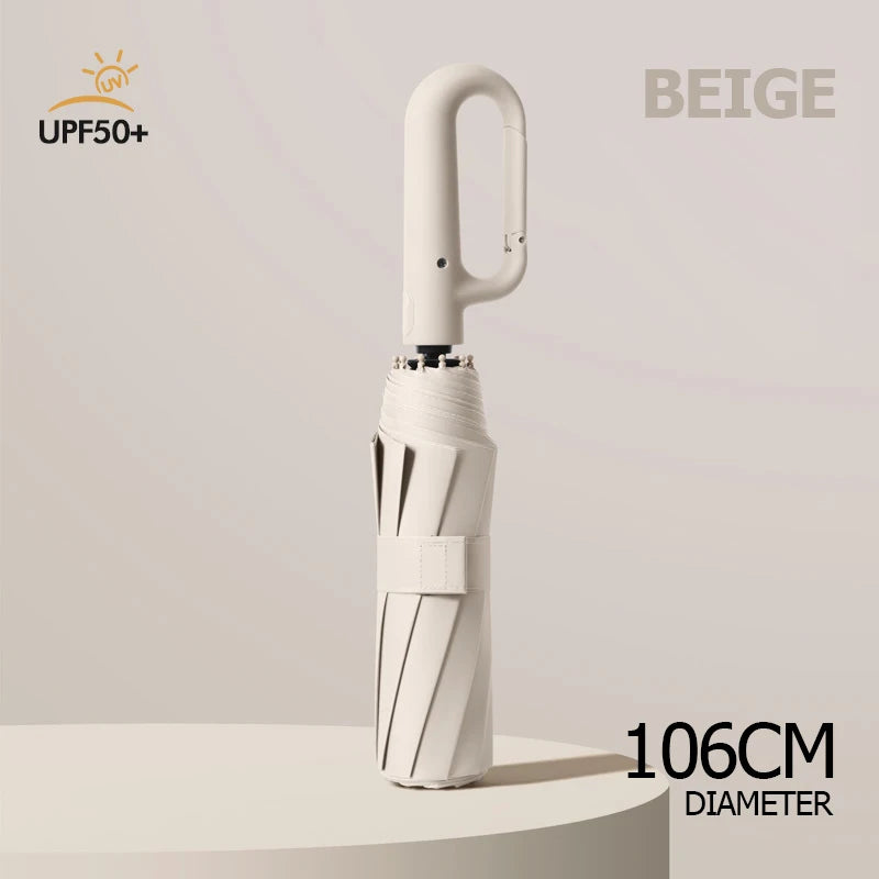 A beige windproof reverse folding umbrella with a reflective stripe and carabiner handle, shown vertically.