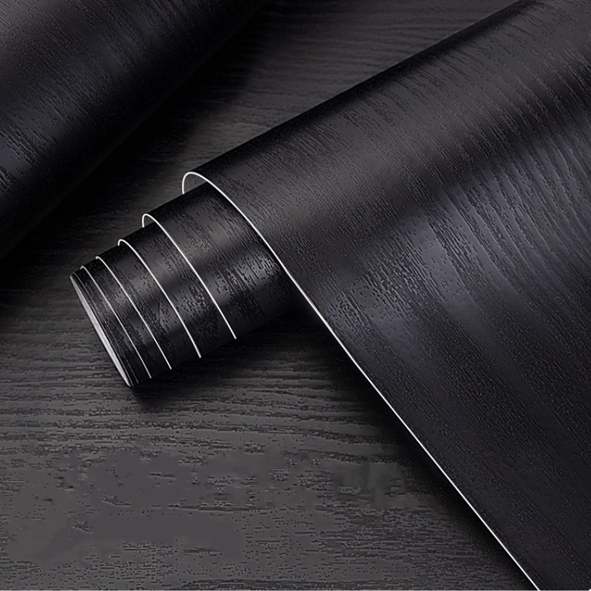 A roll of self-adhesive wood grain wallpaper showing the textured surface and rolled edge.