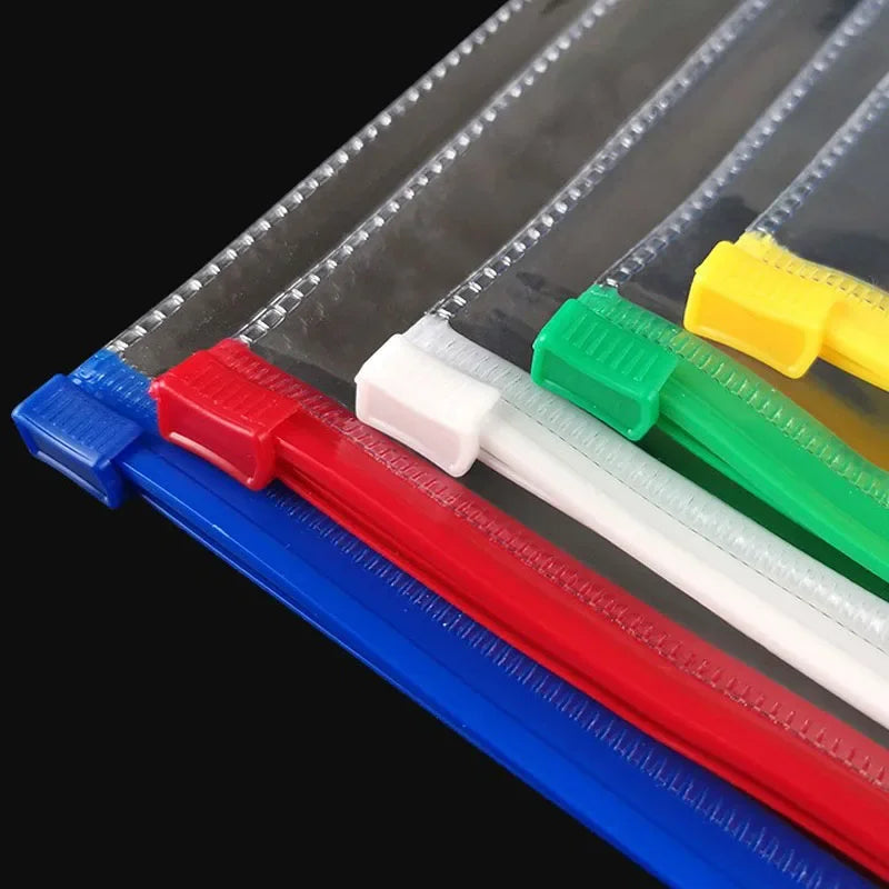 A close-up view of transparent A4 document organizer pockets with colored dividers and plastic sleeves.
