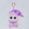 A fluffy pink and purple plush robot with large blue LED eyes is hanging by a gold ring.