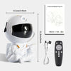 A white astronaut projector night light with a helmet and suit, along with its power cord and remote control.