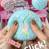 Hands squeeze a cracked light blue squishy stress ball under a magnifying glass.