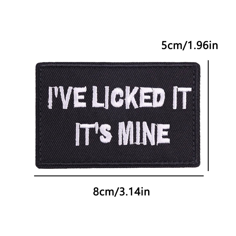 Black embroidered iron-on patch with white text that reads I'VE LICKED IT IT'S MINE