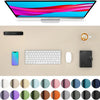 A desk pad featuring a monitor, smartphone, keyboard, mouse, and notebook, surrounded by various colored circles.