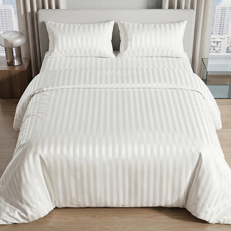 White satin striped jacquard duvet cover set on a bed with light curtains.
