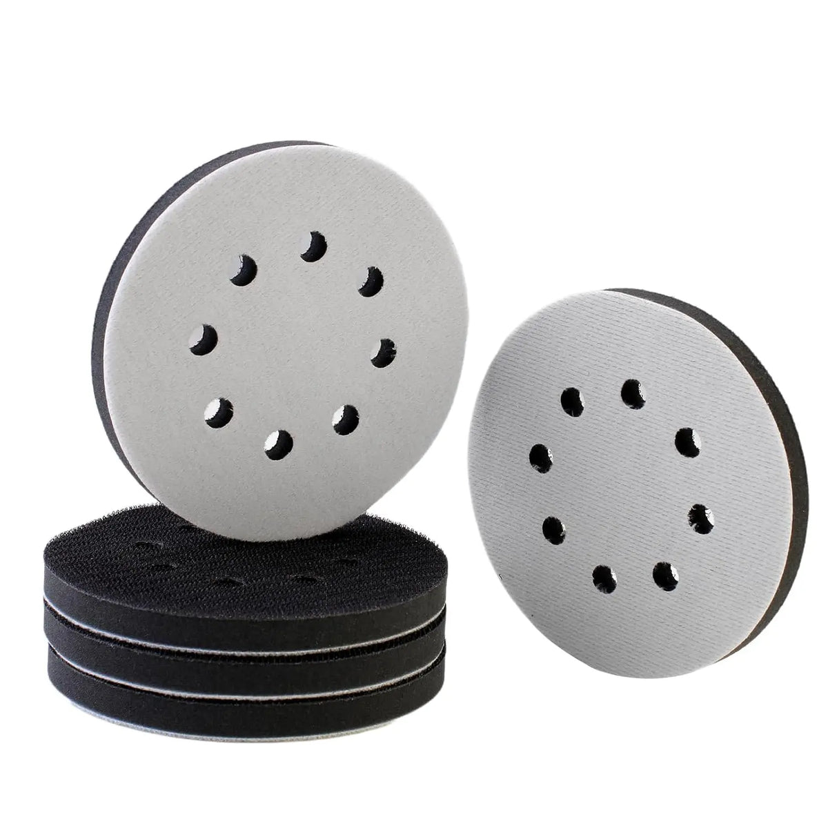 Two circular gray foam sanding pads and a stack of black sanding pads for random orbit sanders