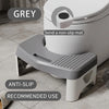 A grey comfort squatting stool with an anti-slip tray is shown next to a toilet.